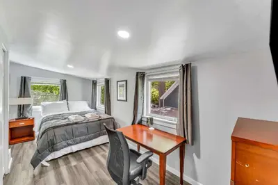 a bedroom with a bed and a desk and a desk at Pitcher's Paradise Apt 3 All Star Baseball Rentals in Oneonta