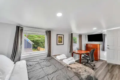 a bedroom with a bed and a desk and a computer at Pitcher's Paradise Apt 3 All Star Baseball Rentals in Oneonta