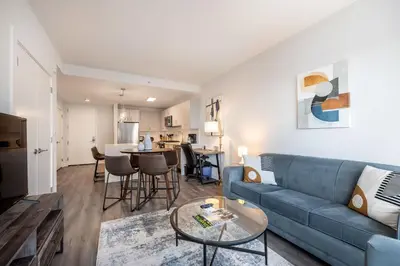 a living room with a blue couch and a table at Luxury Modern Apt with Pool in Stamford