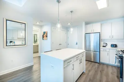 a kitchen with white cabinets and a white counter top at Luxury Modern Apt with Pool in Stamford