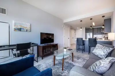 a living room with a couch and a table at Chic Apt with Indoor Pool & Gym-333-2509 in New Rochelle