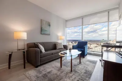 a living room with a couch and a table at Chic Apt with Indoor Pool & Gym-333-2509 in New Rochelle