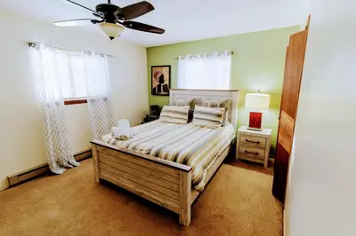 a bedroom with a bed and a ceiling fan at The CubHouse Poconos getaway in Tobyhanna