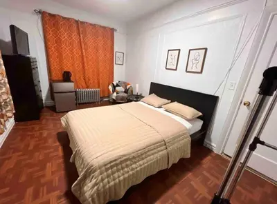 a bedroom with a large bed in a room at Large and spacious room facing a beautiful park minutes away from Manhattan in High Bridge