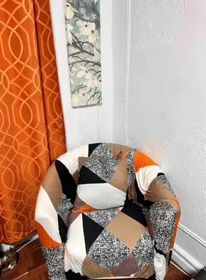 a pile of pillows on a chair in a room at Large and spacious room facing a beautiful park minutes away from Manhattan in High Bridge