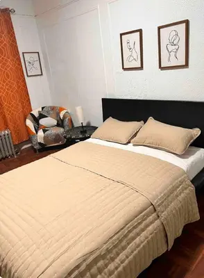 a bedroom with two beds in a room at Large and spacious room facing a beautiful park minutes away from Manhattan in High Bridge