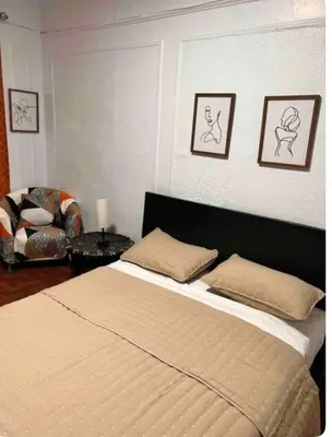 a bedroom with a large bed and a chair at Large and spacious room facing a beautiful park minutes away from Manhattan in High Bridge