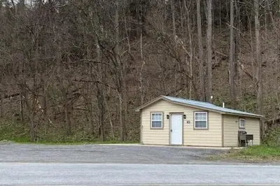 a small shed in the middle of a parking lot at Cozy Cottage in the Catskills! in Oak Hill