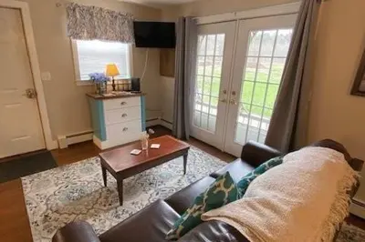 a living room with a couch and a coffee table at Cozy Cottage in the Catskills! in Oak Hill