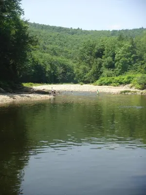 a body of water with people on the shore at The Glow Room at Indian Hollow in Chesterfield