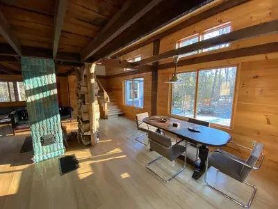 a dining room with a table and chairs in a cabin at The Glow Room at Indian Hollow in Chesterfield