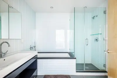 a bathroom with a tub and a glass shower at Hells Kitchen 1BR w Doorman nr Central Park NYC-521 in New York