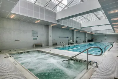 a large indoor swimming pool with water in it at Hells Kitchen 1BR w Doorman nr Central Park NYC-521 in New York