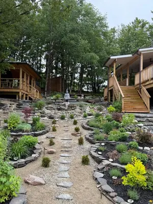 a garden with rocks and plants in a yard at Catskills Mountain Retreat - Luxury Meets Serenity in Jewett