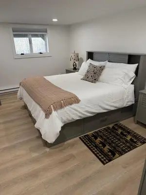 a bedroom with a large bed and a wooden floor at Catskills Mountain Retreat - Luxury Meets Serenity in Jewett