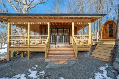 a large wooden cabin with a large deck at Catskills Mountain Retreat - Luxury Meets Serenity in Jewett