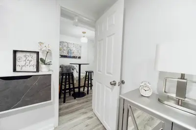 a kitchen with a white door and a dining room at 3BR Private Apt near LGA, JFK, Manhattan, Northern Blvd in Jackson Heights