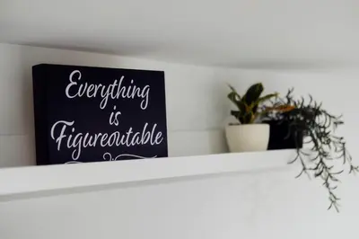 a chalkboard sign on a white shelf with a plant at 3BR Private Apt near LGA, JFK, Manhattan, Northern Blvd in Jackson Heights