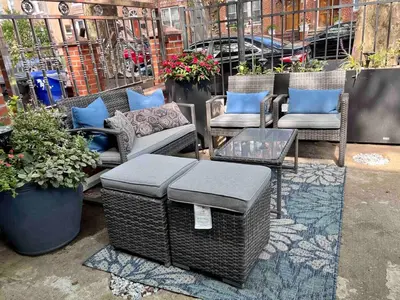 a patio with wicker furniture and a table and chairs at 3BR Private Apt near LGA, JFK, Manhattan, Northern Blvd in Jackson Heights