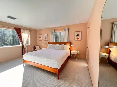 a bedroom with a large bed and a mirror at Luxury Woodstock Retreat Hot tub heated pool in Woodstock
