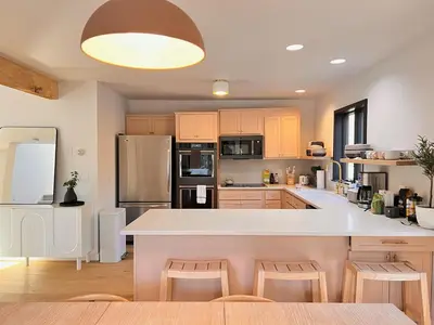a large kitchen with a large white counter top at Luxury Woodstock Retreat Hot tub heated pool in Woodstock