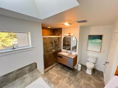 a bathroom with a toilet and a shower and a sink at Luxury Woodstock Retreat Hot tub heated pool in Woodstock