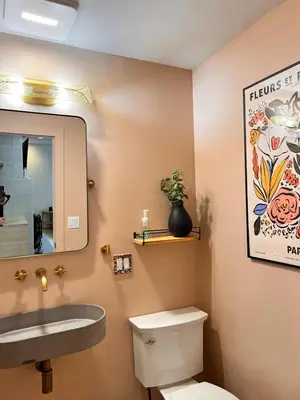 a bathroom with a sink and a toilet and a mirror at Luxury Woodstock Retreat Hot tub heated pool in Woodstock