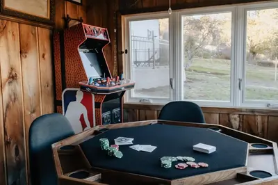 a room with a table and chairs and a game table at Majestic views Hot tub Firepit Games Sleeps 14 in Hillsdale