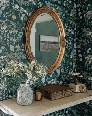 a mirror on a wall with a vase of flowers at Majestic views Hot tub Firepit Games Sleeps 14 in Hillsdale