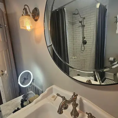 a bathroom with a sink and a mirror at Peach Grove House in Warwick