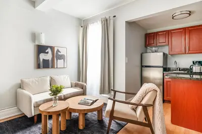 a living room with a couch and a table at 73-812 New Studio UWS Doorman Gym in New York