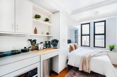 a white kitchen with a bed and a window at 73-1509 New Studio UWS Doorman Gym in New York