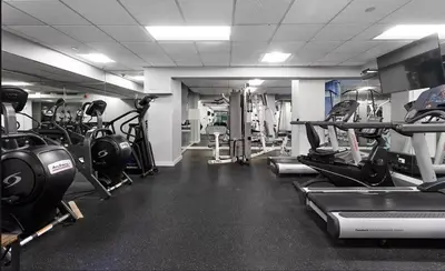 a gym with lots of treadmills and machines at 73-1509 New Studio UWS Doorman Gym in New York