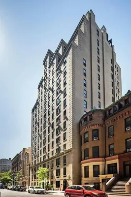 a large tall building with cars parked in front of it at 73-1509 New Studio UWS Doorman Gym in New York