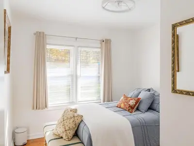 a bedroom with a bed and a window at The Meyer spacious family home with hot tub in New Paltz
