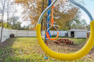 a swing in a yard with a picnic table at The Meyer spacious family home with hot tub in New Paltz