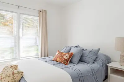 a bedroom with a bed with pillows and a window at The Meyer spacious family home with hot tub in New Paltz