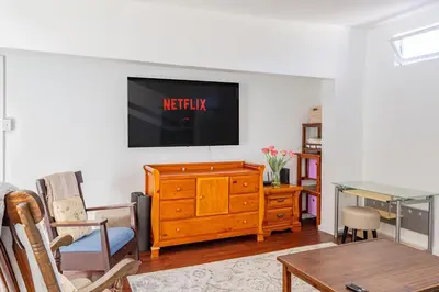 a living room with a television on a wall at The Meyer spacious family home with hot tub in New Paltz