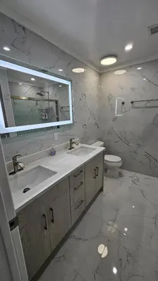 a bathroom with a sink and a toilet and a mirror at 3 Bedroom Renovated Model House in New Hyde Park