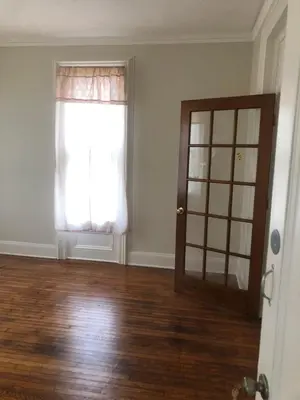 an empty room with a window and a door at Home Support And Care LLC in Binghamton