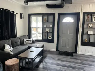 a living room with a couch and a door at Twin Pines Lake Resort 1 in Northville
