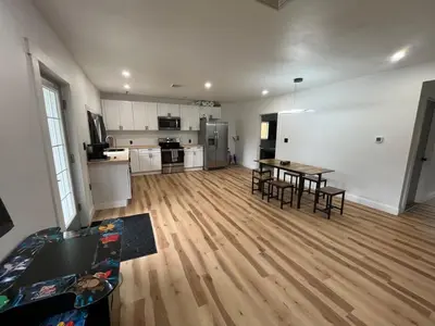 a large living room with a table and a kitchen at Twin Pines Lake resort 2 in Northville