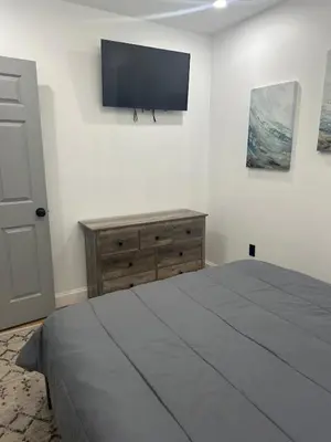 a bedroom with a bed and a flat screen tv at Twin Pines Lake resort 2 in Northville