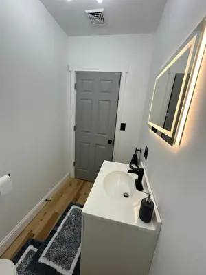 a white bathroom with a sink and a mirror at Twin Pines Lake resort 2 in Northville