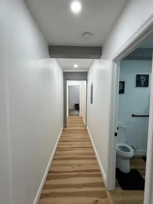 a hallway leading to a bathroom with a toilet at Twin pines 3 in Northville
