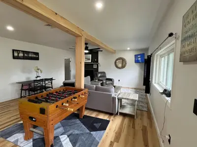 a living room with a couch and a table at Twin pines 3 in Northville
