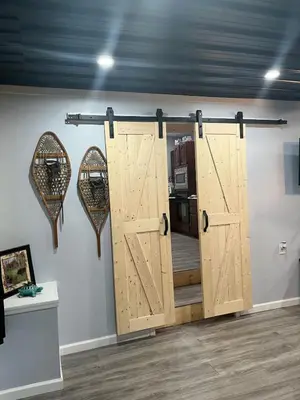 a room with a door and two mirrors on a wall at Brooks bay in Lake Luzerne