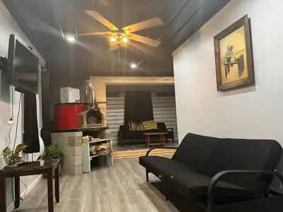 a living room with a couch and a ceiling fan at Brooks bay in Lake Luzerne