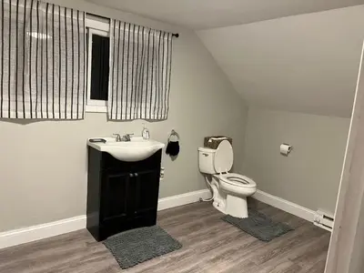 a bathroom with a sink and a toilet at Brooks bay in Lake Luzerne