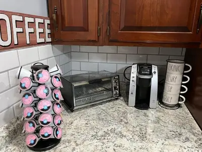 a kitchen counter with a toaster oven and cupcakes at Brooks bay in Lake Luzerne